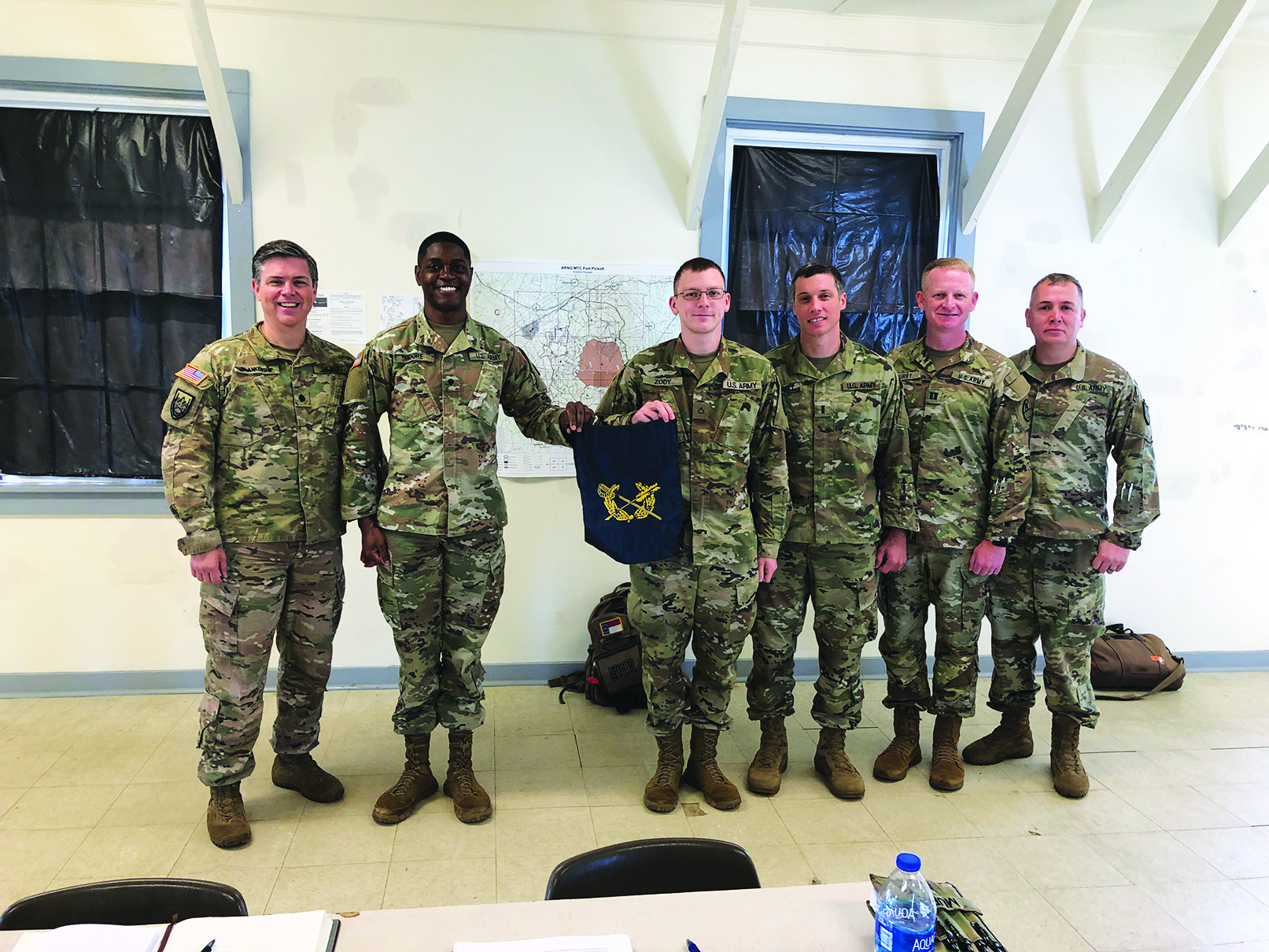 Members of the North Carolina Army National Guard JAG Corps come together after an administrative separation board conducted during annual training at Fort Pickett, VA. Pictured from L to R: LTC Brian Blankenship, SPC John Moore, PFC Brian Zody, 1LT Chris Harrell, CPT Tom Murry, and MAJ Scott Somerset.